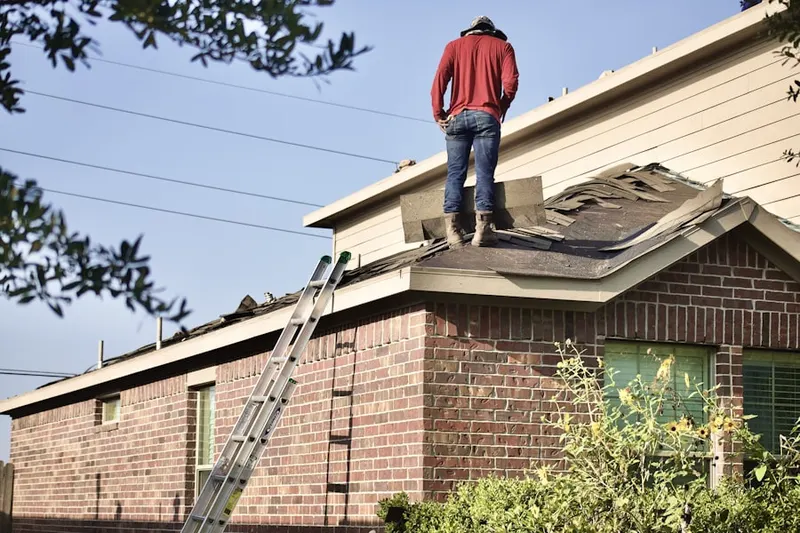 Professional roofer working on a residential roof in Mountain Lakes